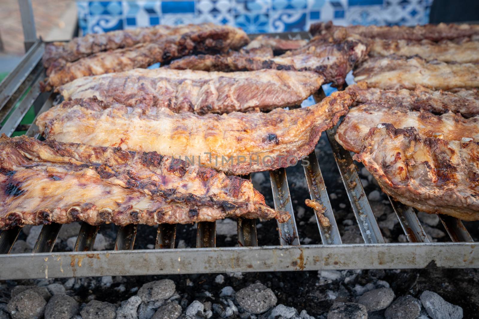 rack of pork ribs lined up on a outdoor grill by Robertobinetti70