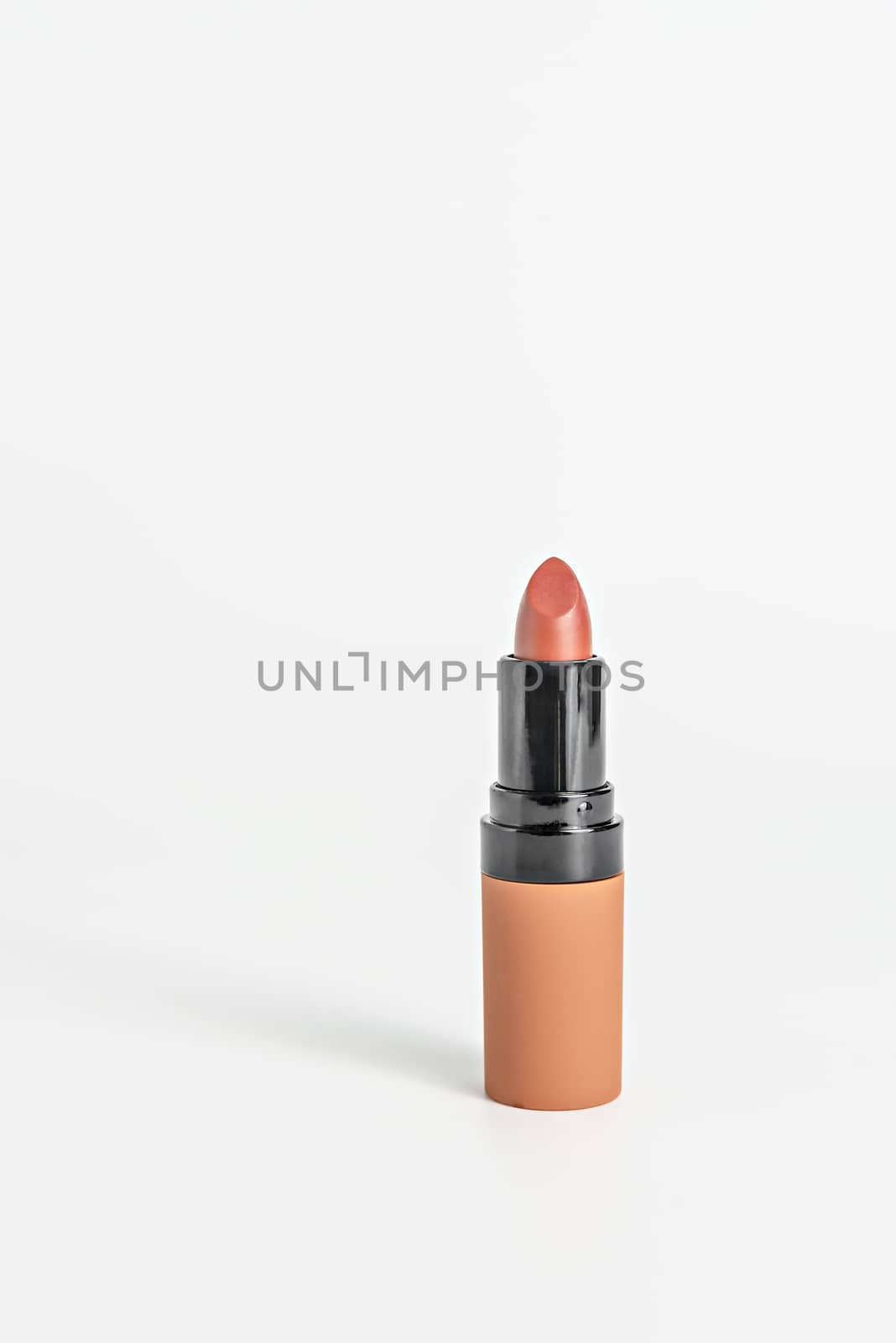 close up orange color lipstick on white background