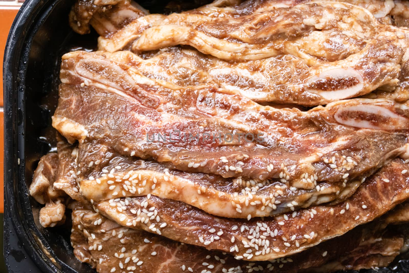 Bowl with stack of raw beef rib steaks