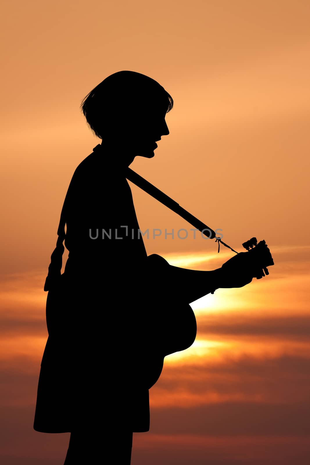 illustration of girl sings and plays guitar at sunset