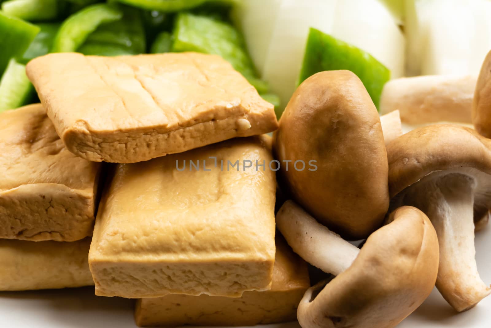 Green peppers, tofu, onion, and mushrooms in plate