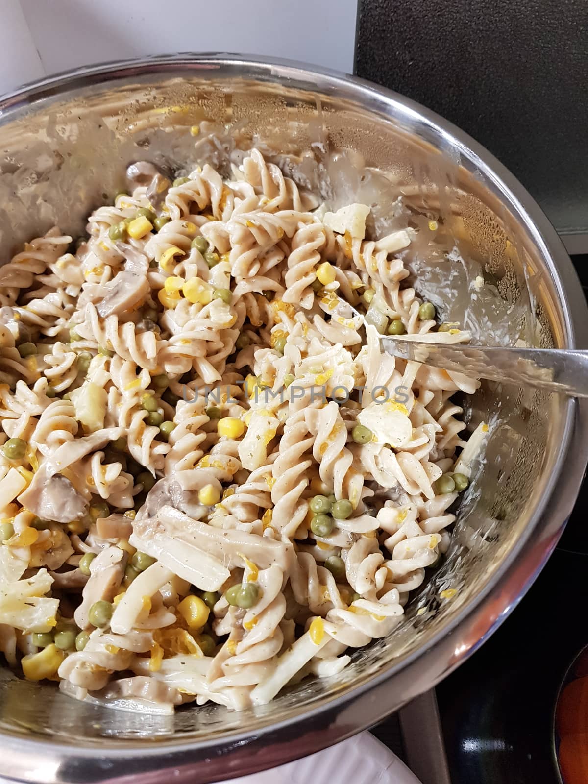 Homemade pasta salad with freshly chopped basil and tomatoes