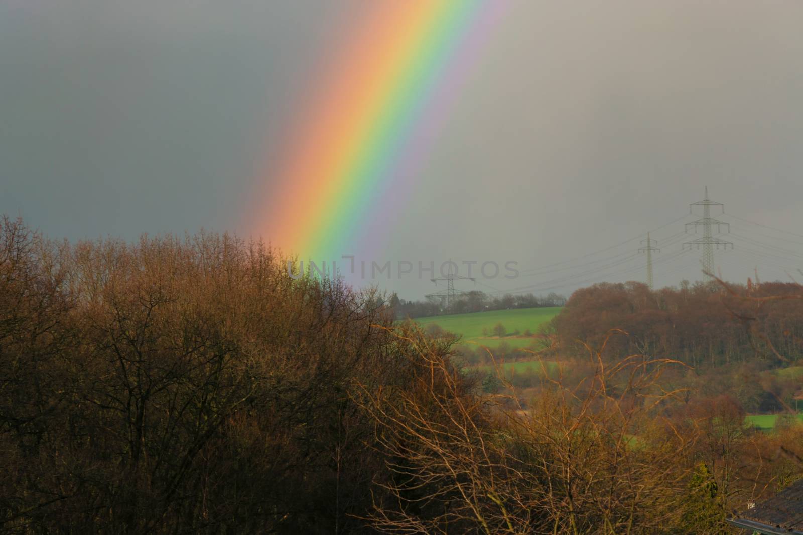 Rainbow over the spring green field by JFsPic