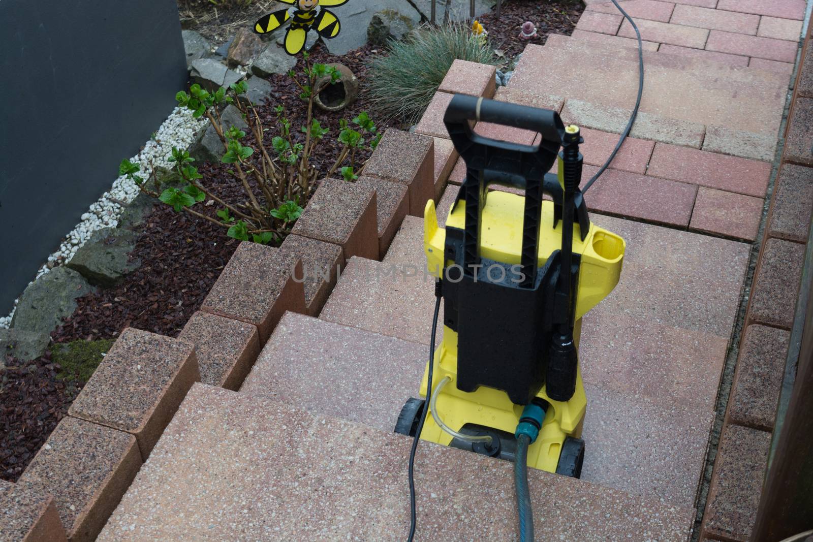 Yellow pressure washer on a staircase by JFsPic