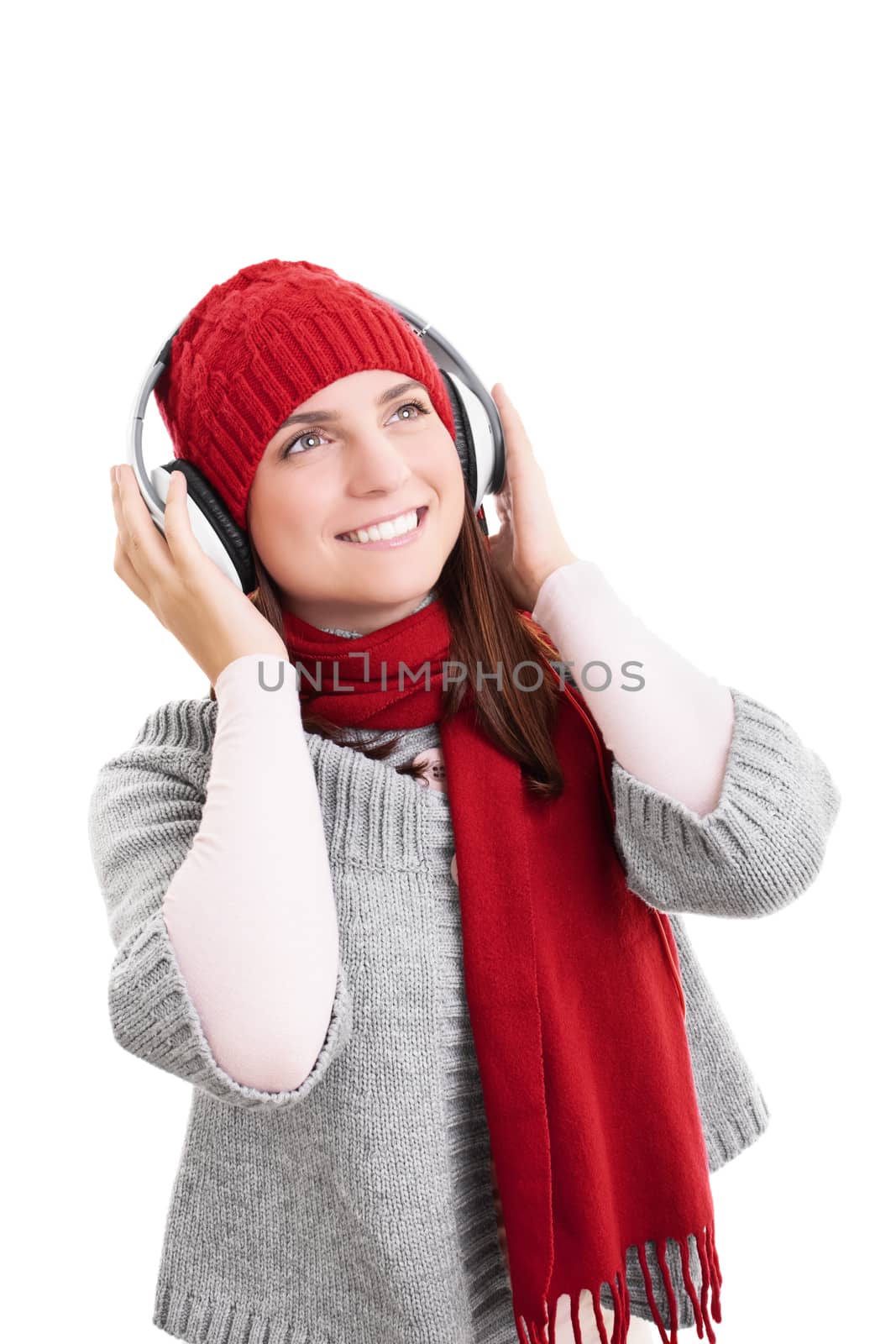 Smiling girl in winter clothes with headphones by Mendelex