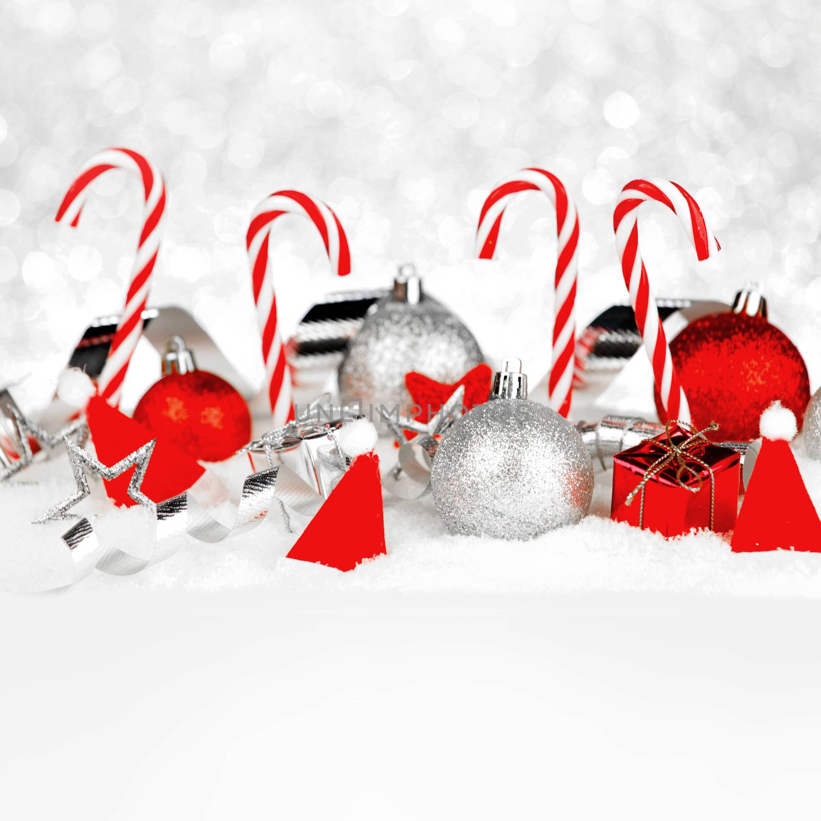 Christmas card with beautiful decorations and candies in snow