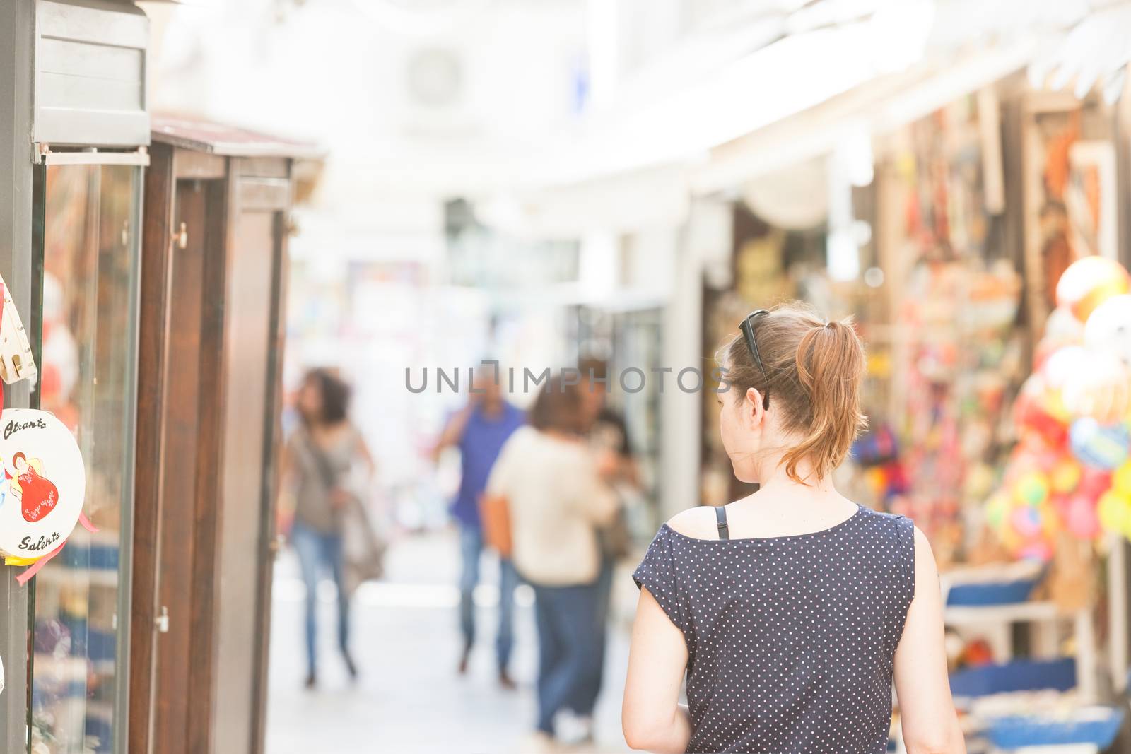 Otranto, Apulia - A woman walking through the pedestrian zone of by tagstiles.com