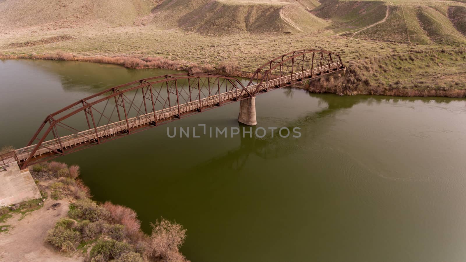 areal view of guffy bridge as it crosses a river in idaho