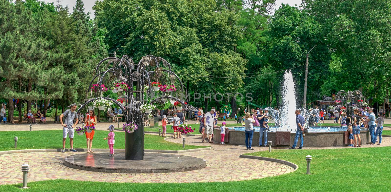 Odessa, Ukraine - 06.09.2019. People spend their families relaxing by the fountain in Gorky Park in Odessa, Ukraine, on a sunny summer day