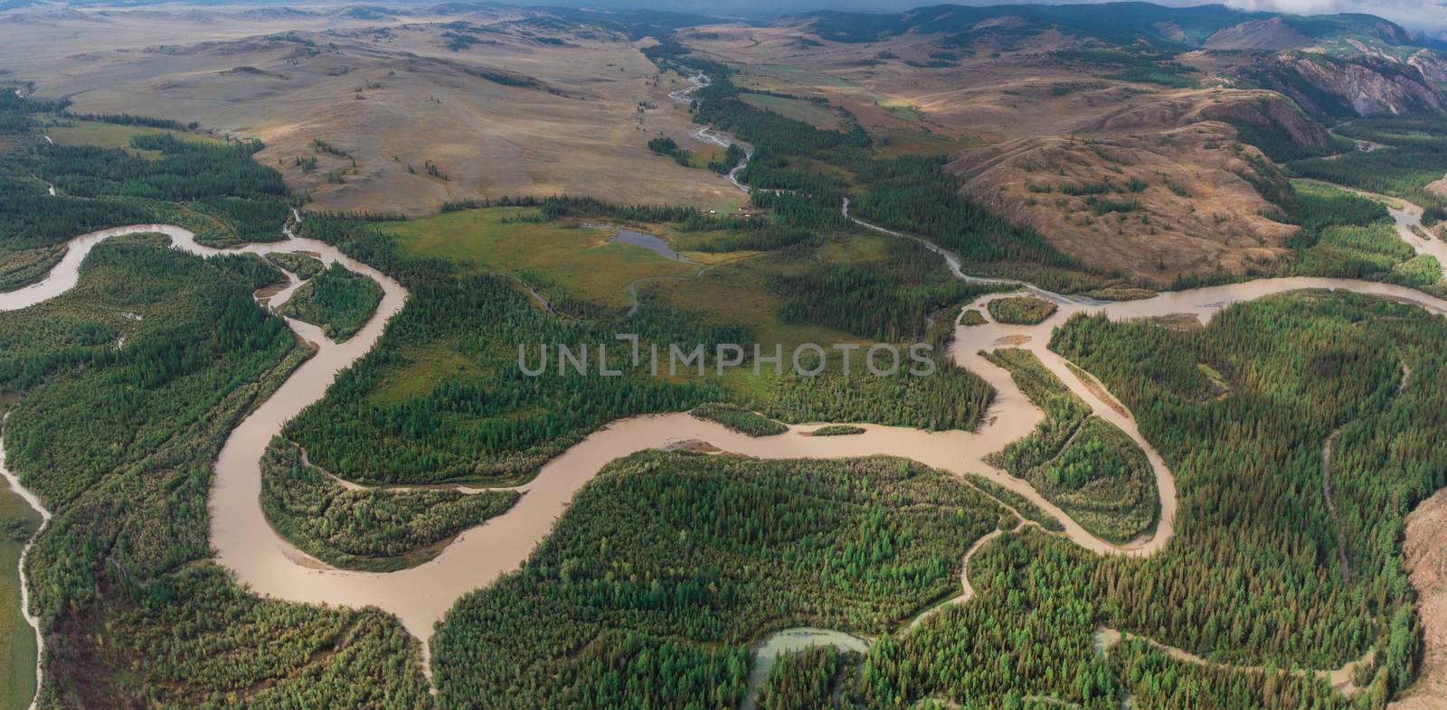 Kurai steppe and Chuya river on North-Chui ridge background. Altai mountains, Russia. Aerial drone panoramic picture.