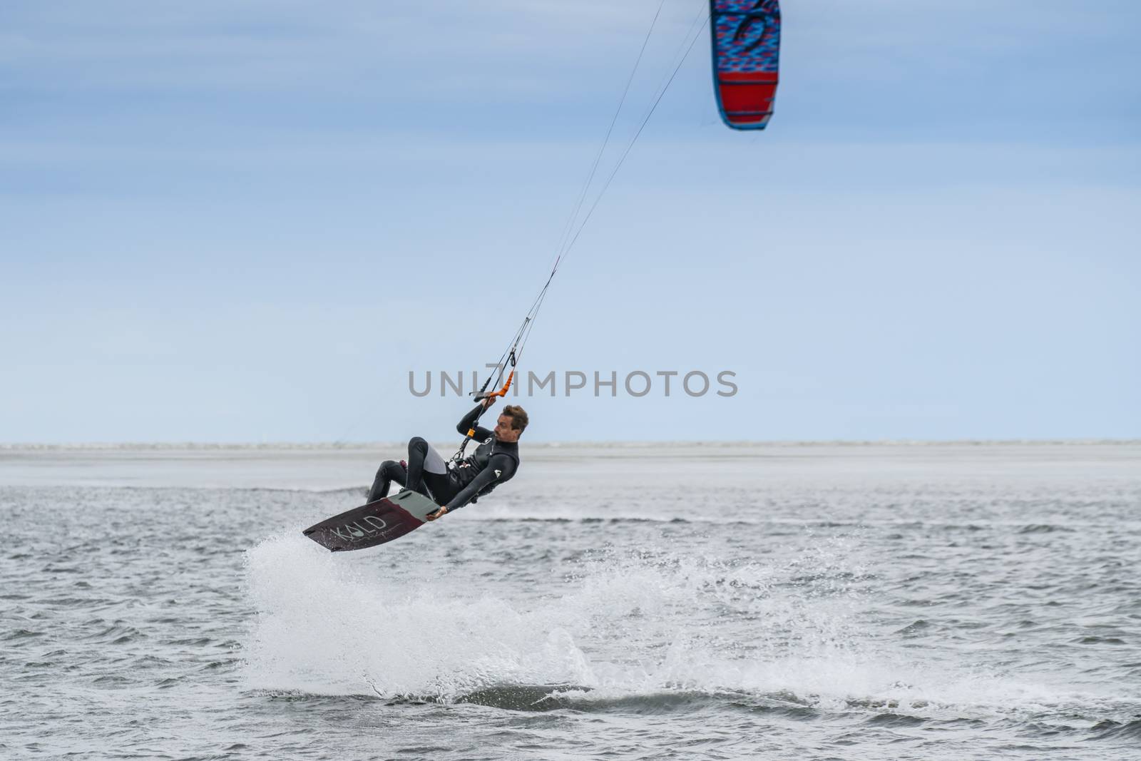 a man doing kitesurf at the sea