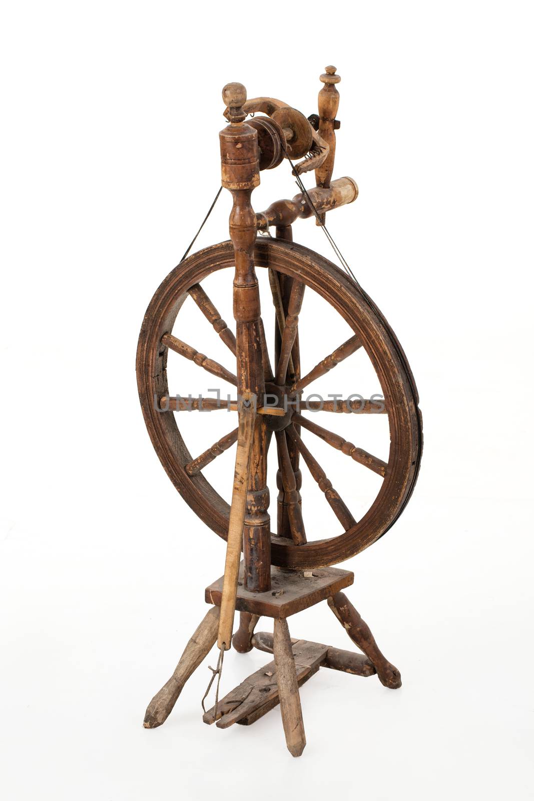 Old spinning wheel on an isolated studio background