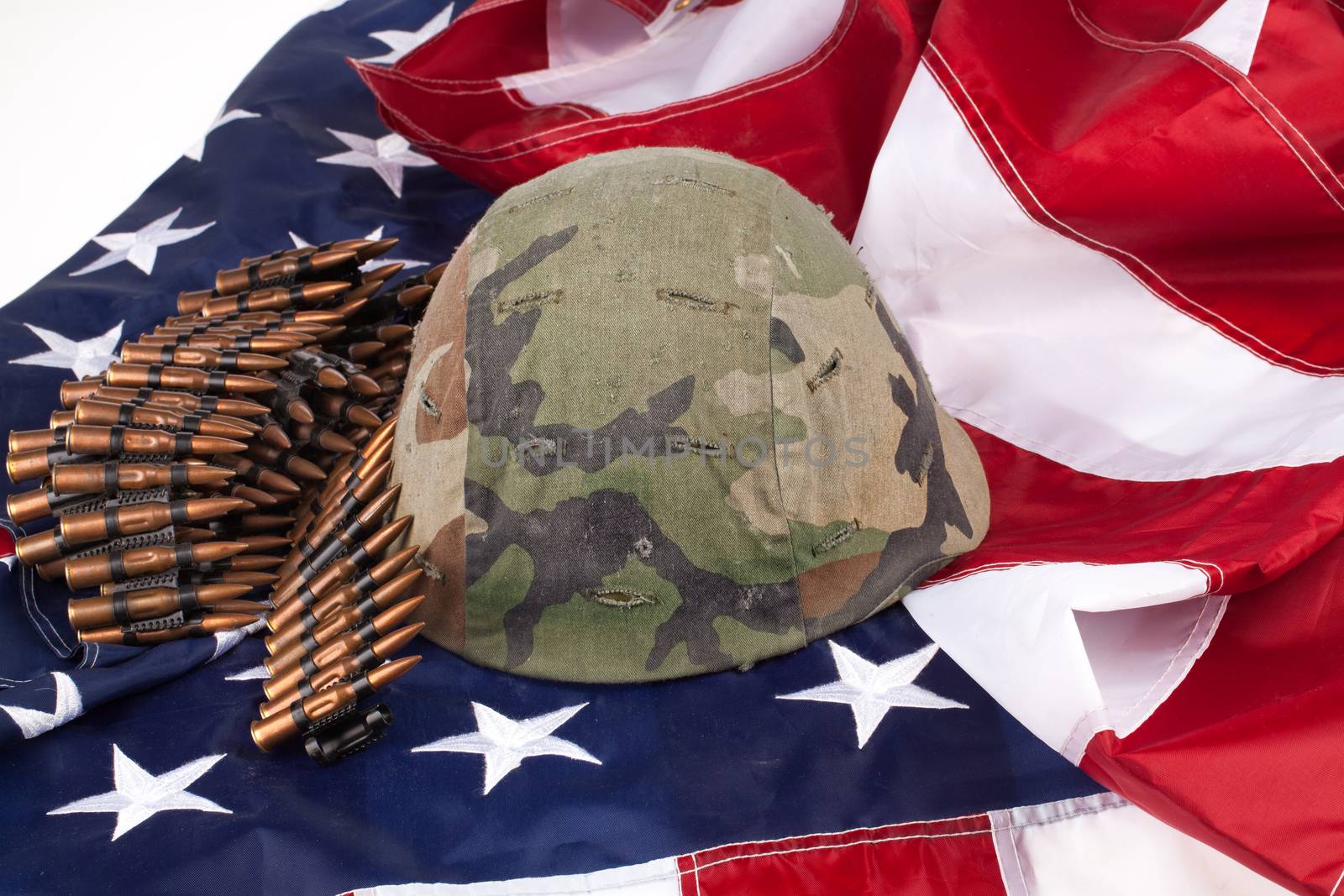 Band with cartdidges and army helmet on an american flag