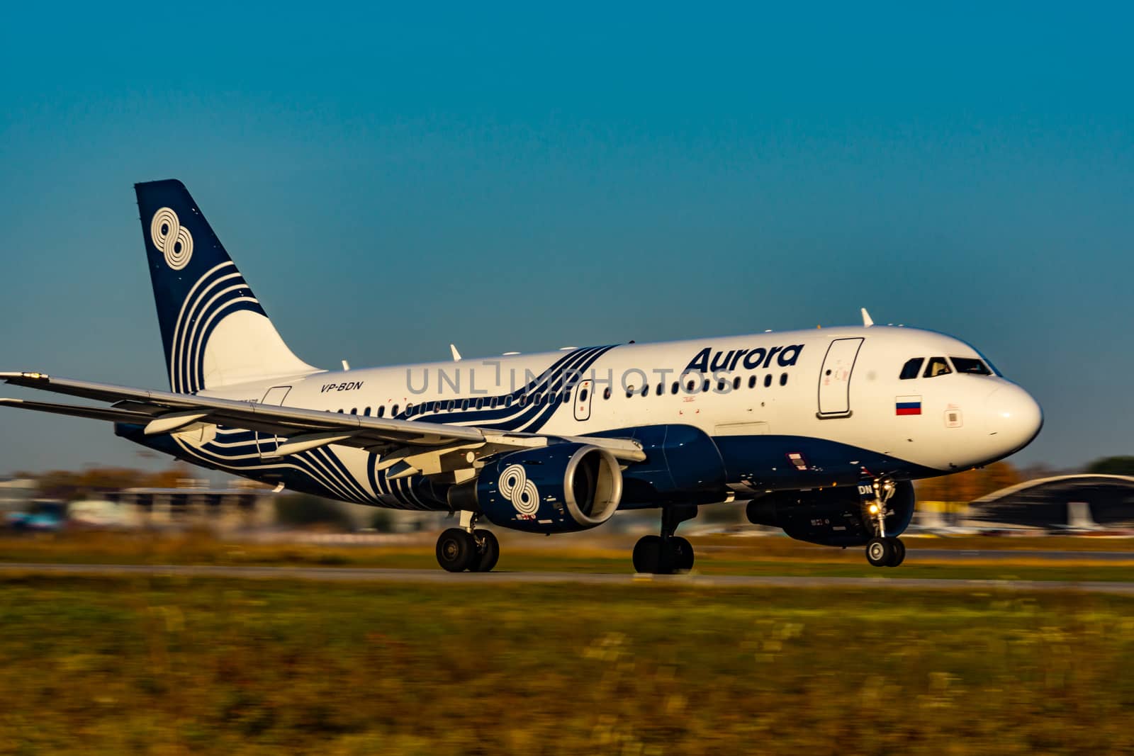 The plane takes off at dawn at high speed. Photo from the runway. Airport Khabarovsk-Novy UHHH , Russia. Airbus A319-111.