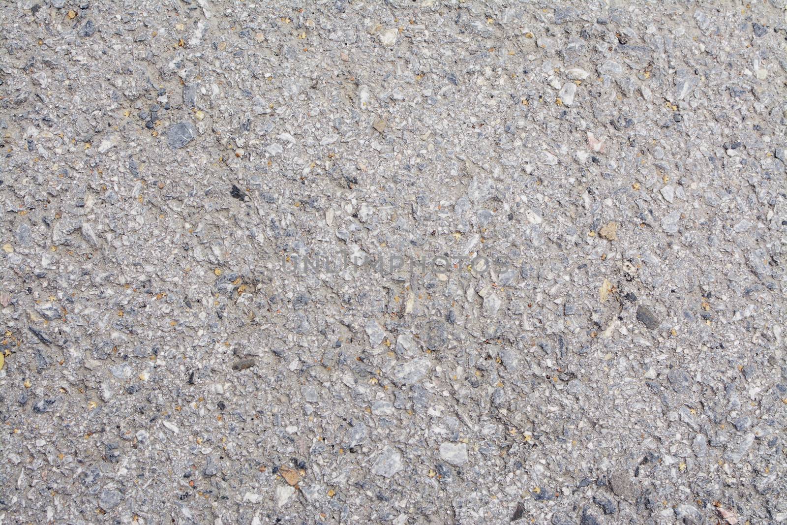 Texture of small stone, old asphalt with a crack, grunge background