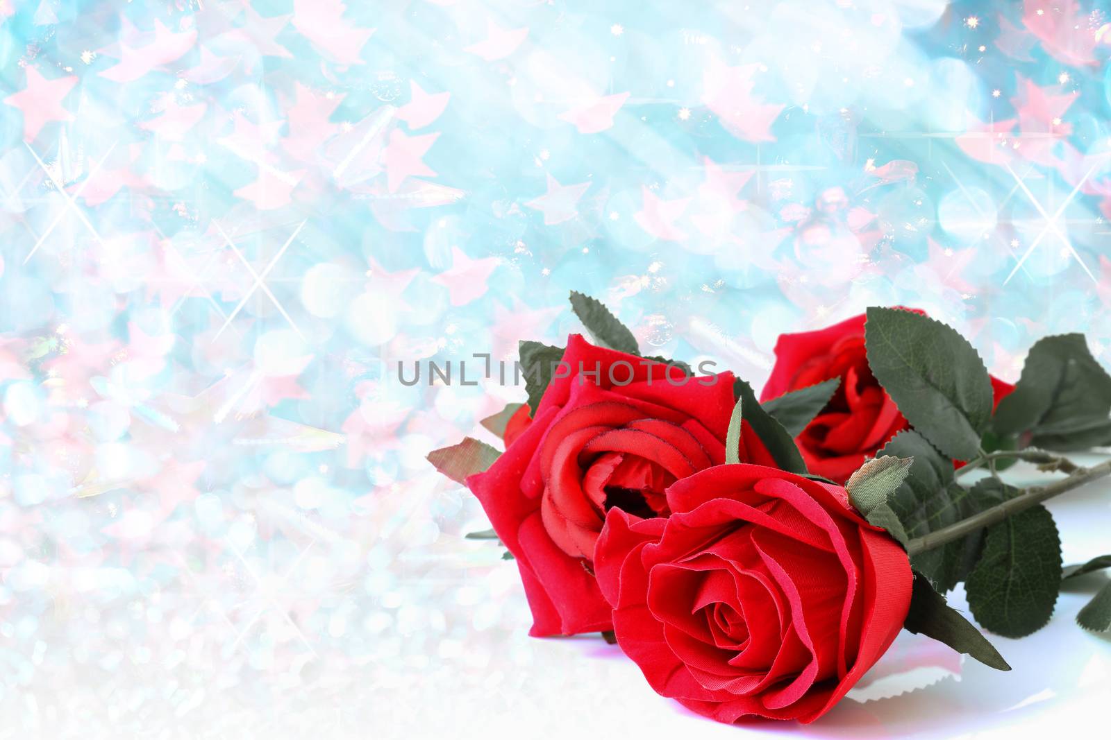Red roses bouquet with blue bokeh and free space for text, valentine twinkled bright background.