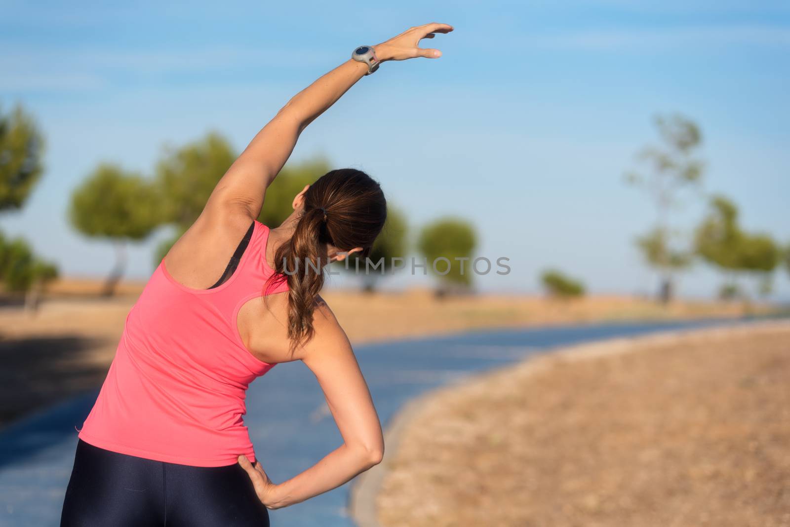 woman doing stretching exercise for back, sport background. by HERRAEZ