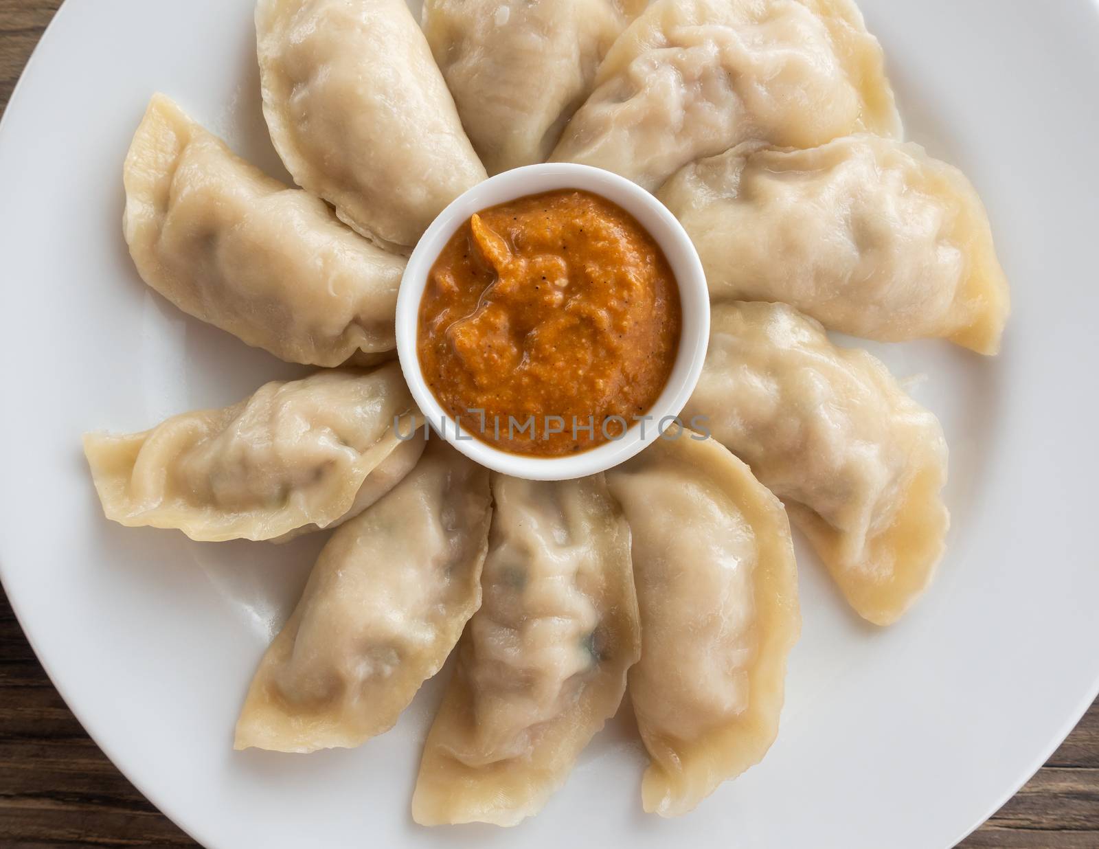 Plate of Nepalese chicken momos and its achar (sauce)
