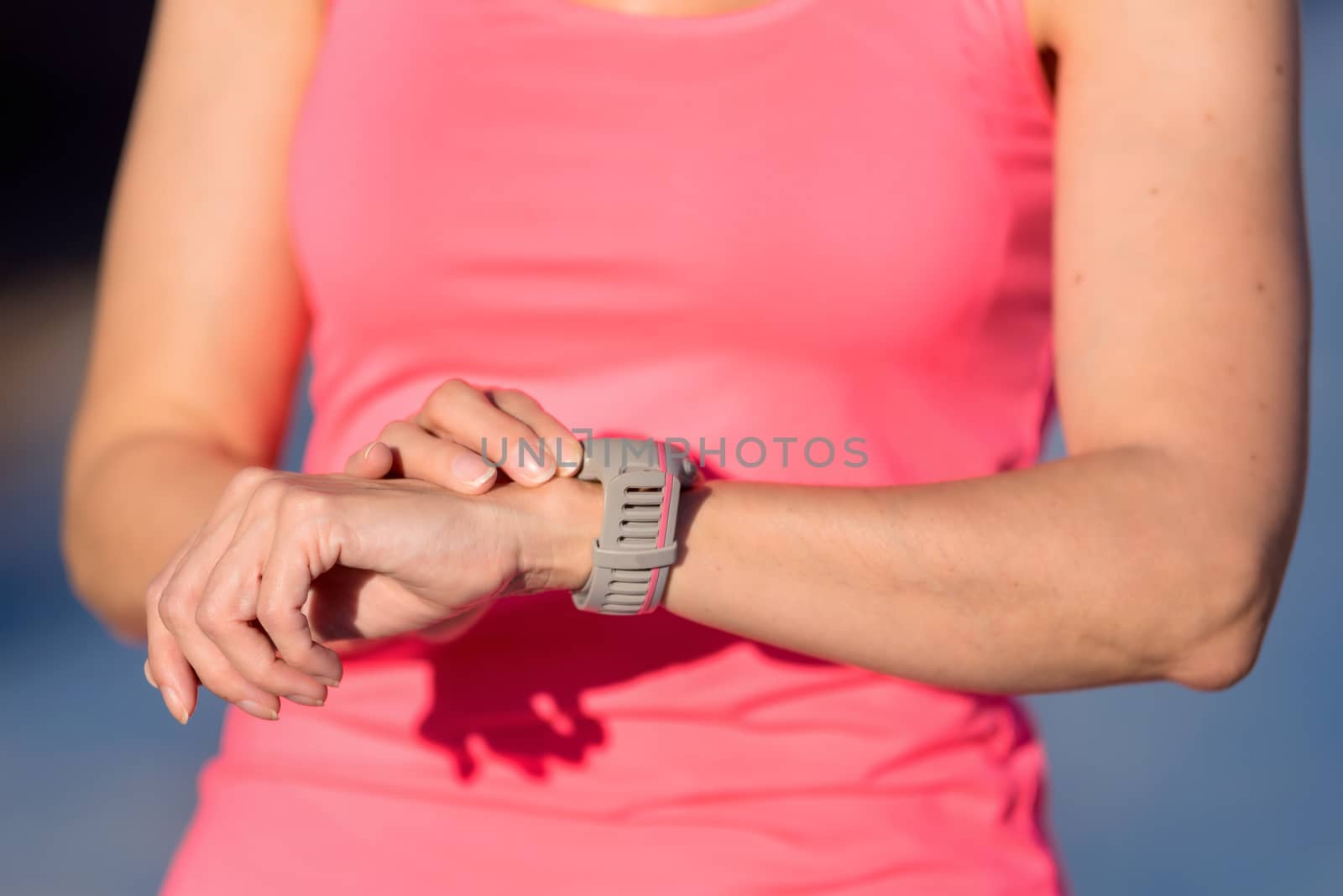 Woman setting up the fitness smart watch for running by HERRAEZ
