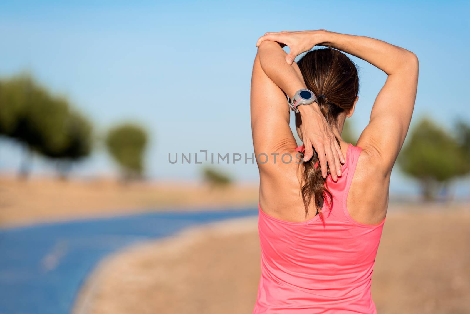 woman doing stretching exercise for arms, sport background. by HERRAEZ