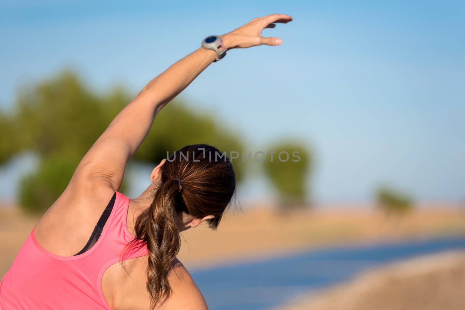 woman doing stretching exercise for back, sport background.