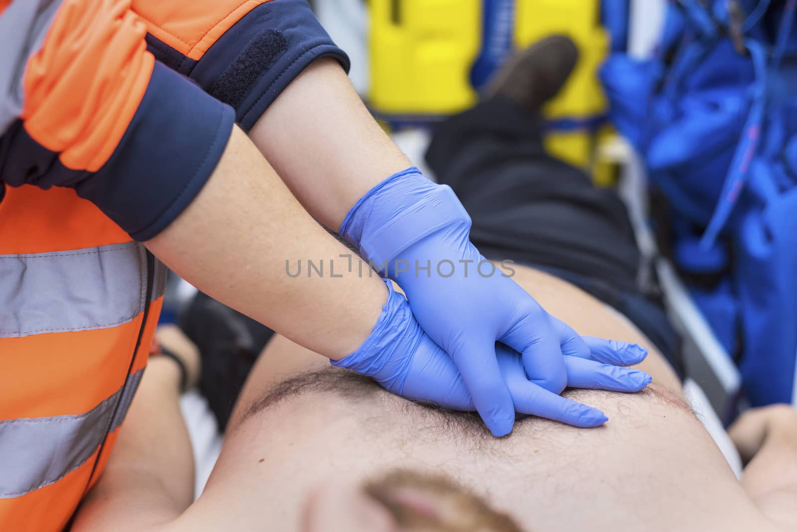 Emergency doctor resuscitate a patient in ambulance. CPR resuscitation. by HERRAEZ
