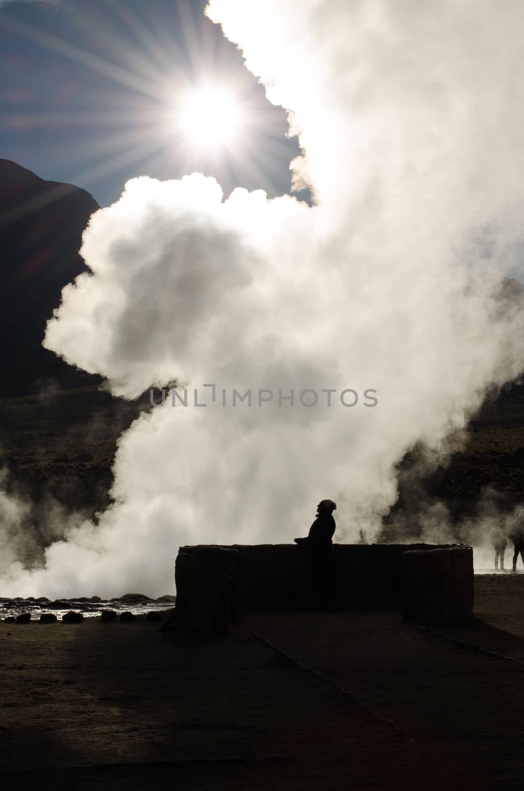 Shocked woman gazes at the sun thrugh a steam veil in Atacama desert, Chile