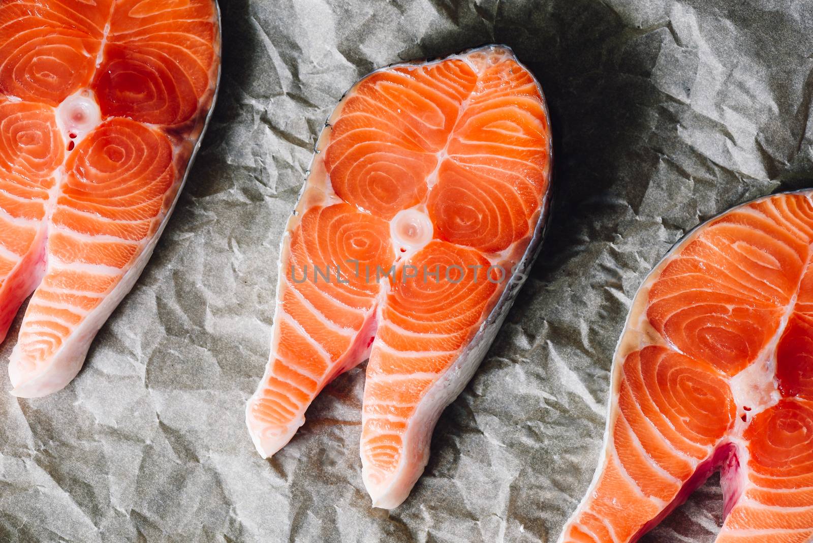 Raw Salmon Steaks on Parchment Paper. View frrom Above.