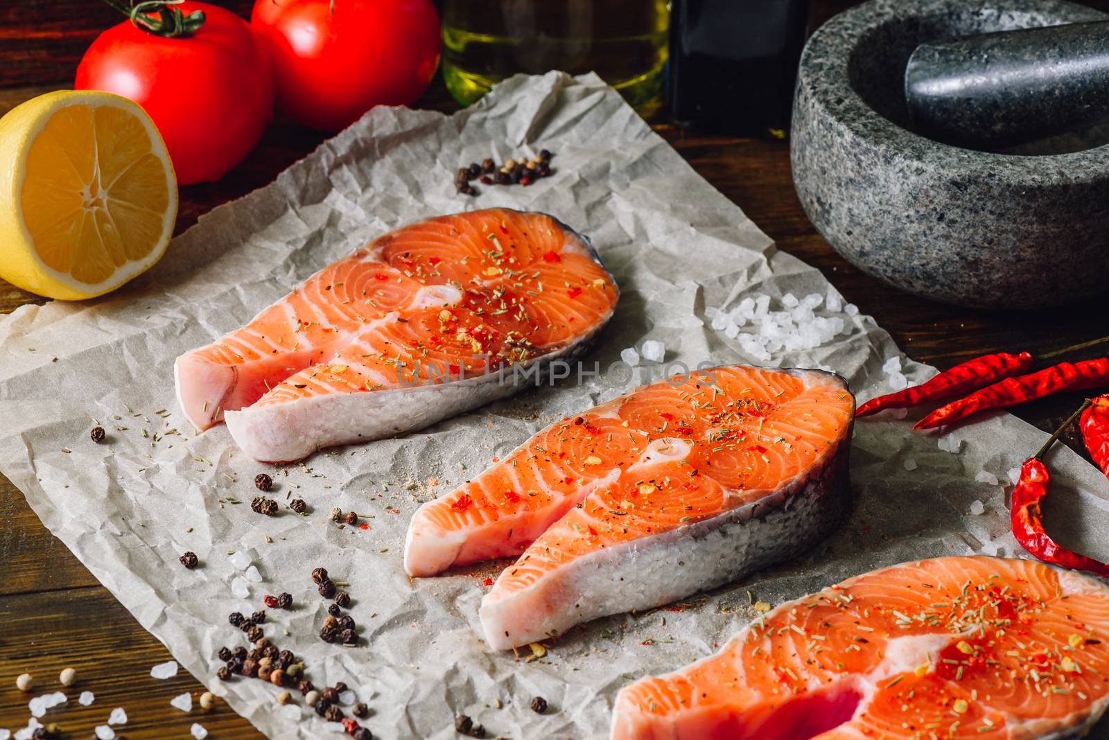 Raw Red Fish and Some Spices on Parchment Paper