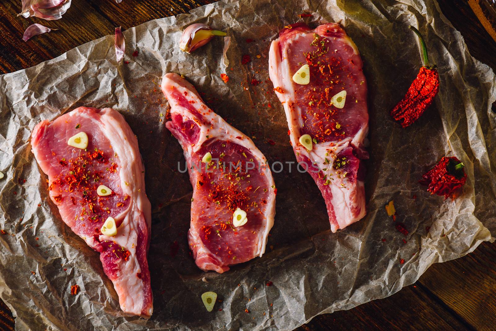 Three Pork Loin Steaks Ready for Cooking. View from Above.