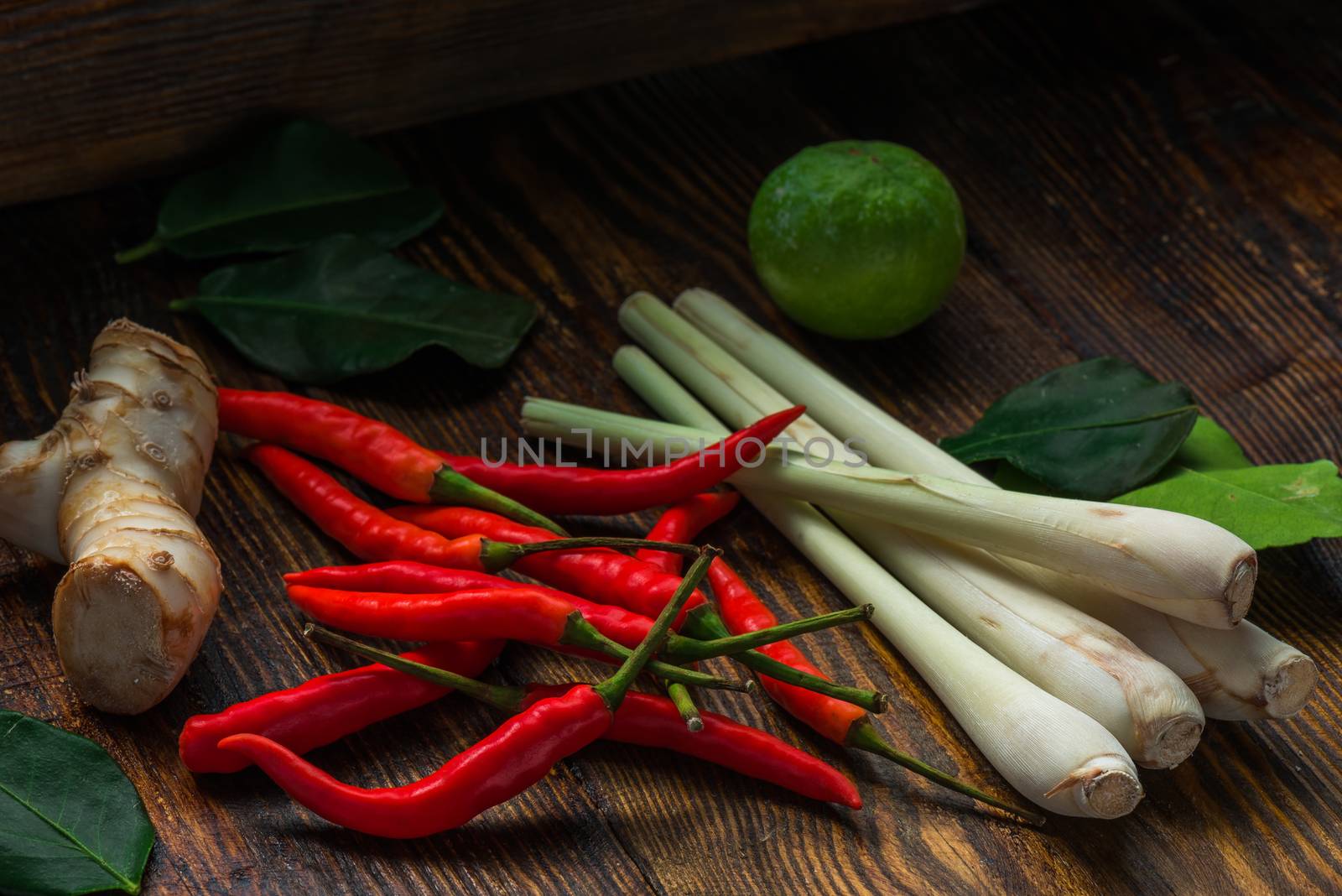 Mini chili peppers, galangal root, kaffir lime with leaves and lemongrass. Ingredients of Thai cuisine.