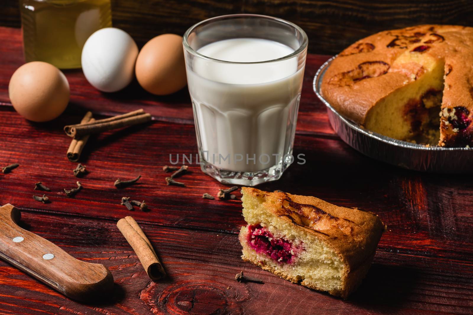 Slice of Cherry Cake with Milk and some Ingredients and Spices