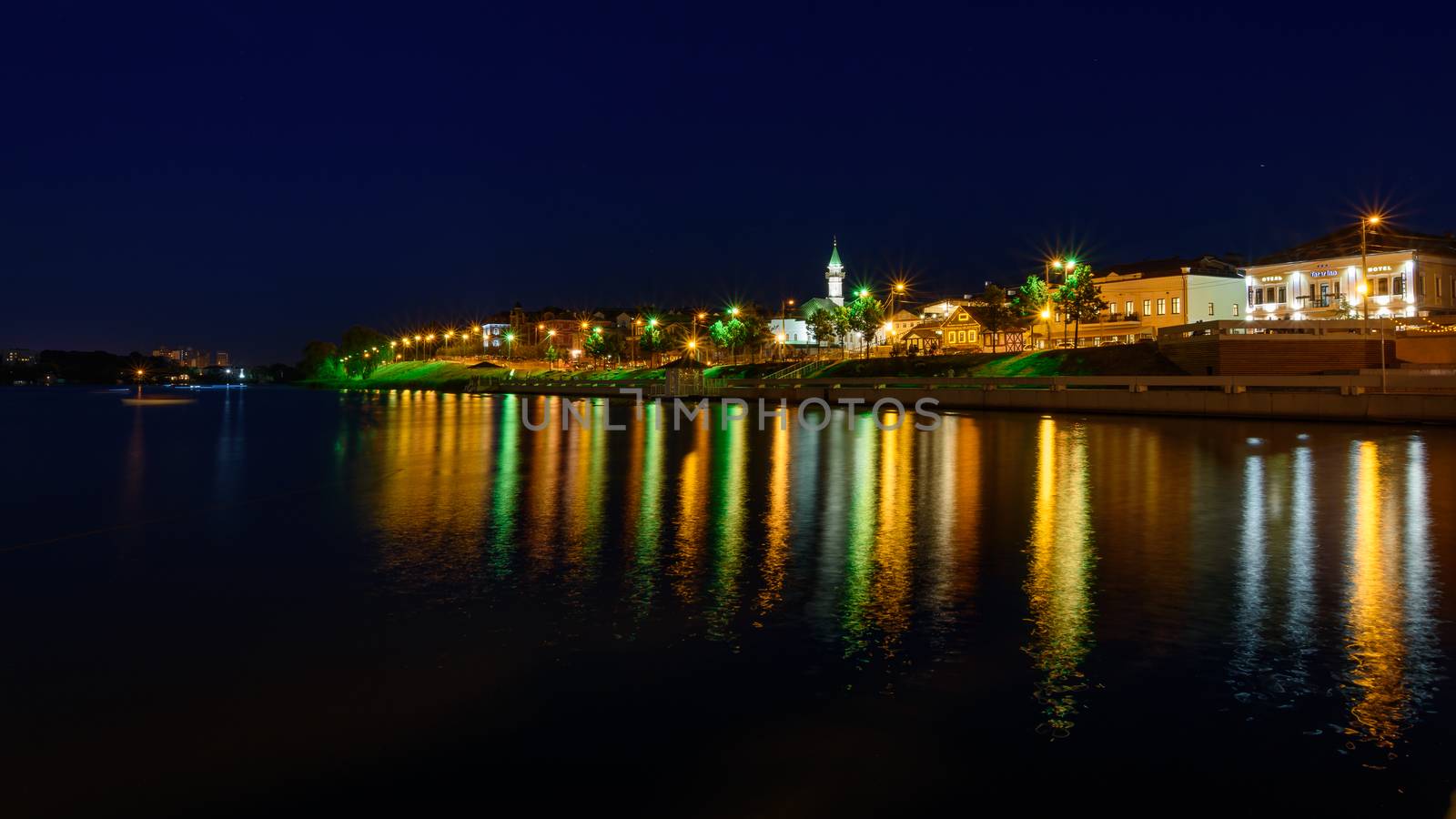 The city of Kazan during a beautiful summer night with multicolor illumination. View of the waterfront of Kaban Lake.