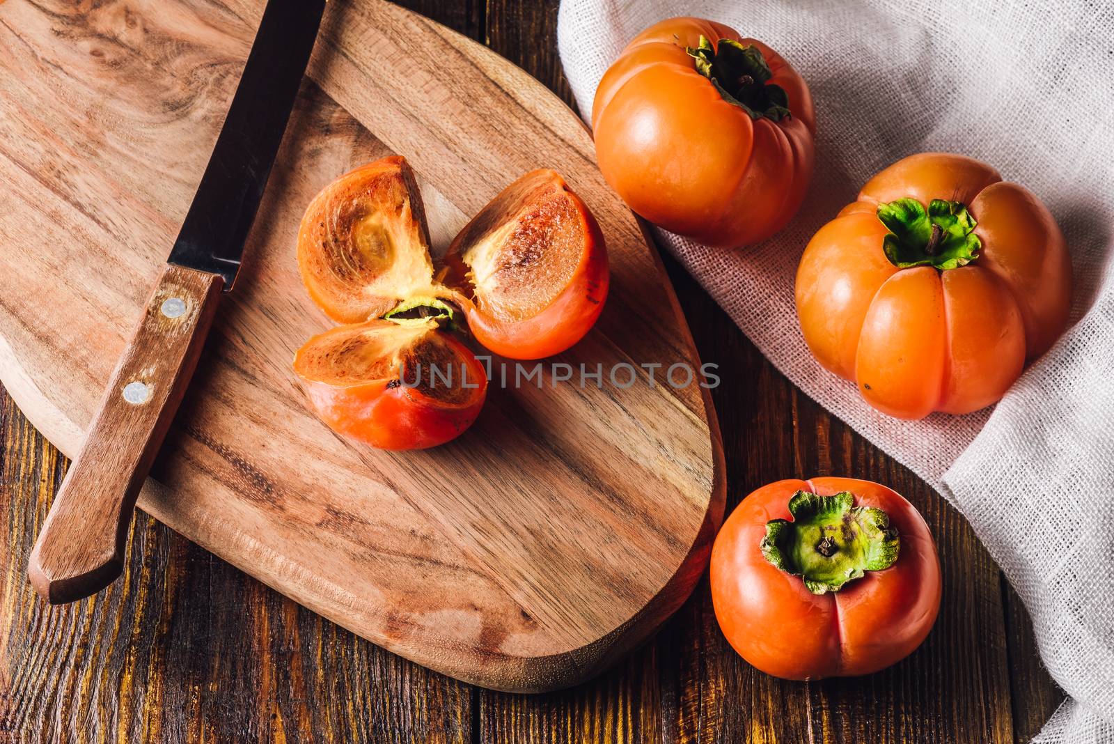 Sliced Persimmon with Knife on Cutting Board