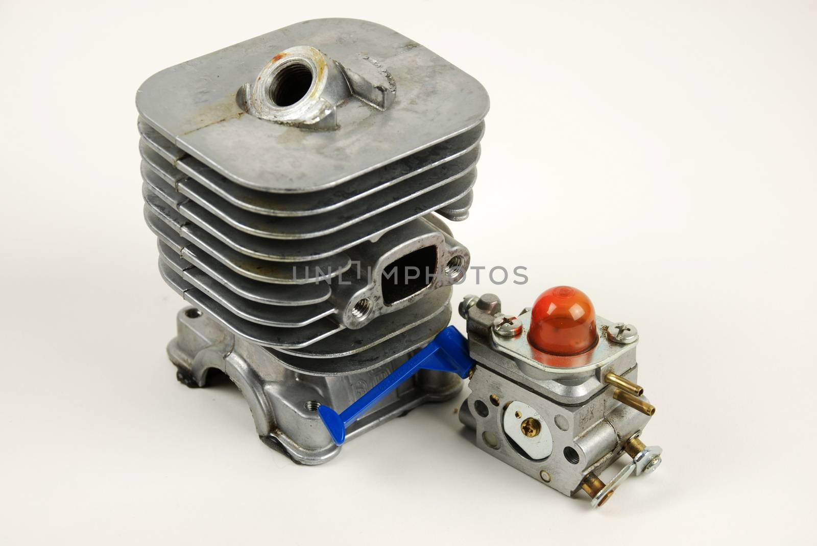 Stock pictures of a small gas engine and a carburetor