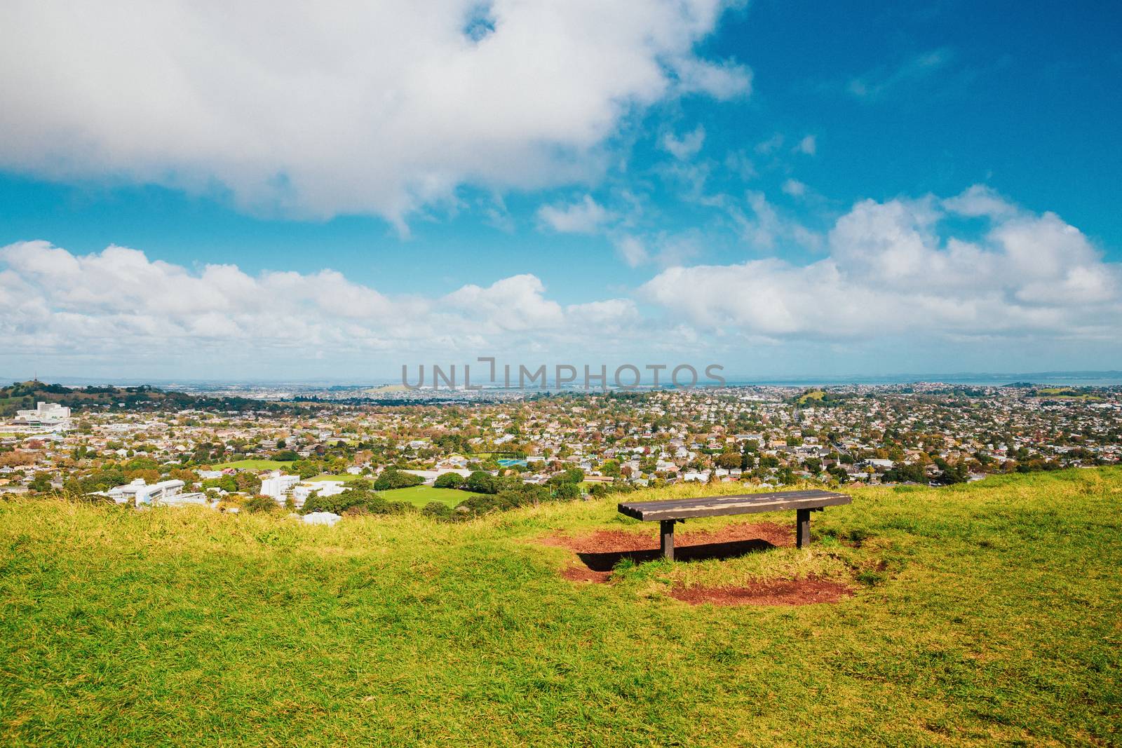 Auckland view from Mt Eden with a person walking along the path towards the city, New Zealand