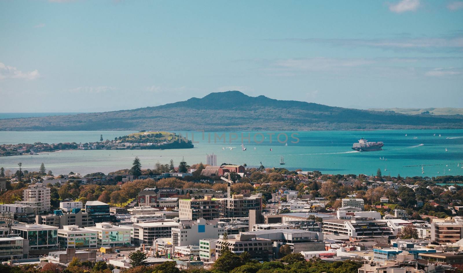 Auckland view from Mt Eden with a person walking along the path towards the city, New Zealand