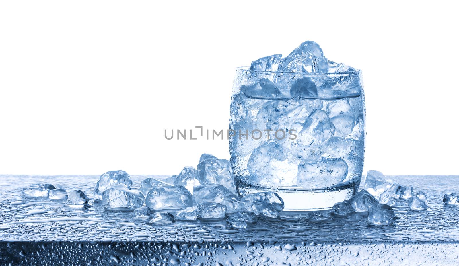 Water with crushed ice cubes in glass on white background by xamtiw