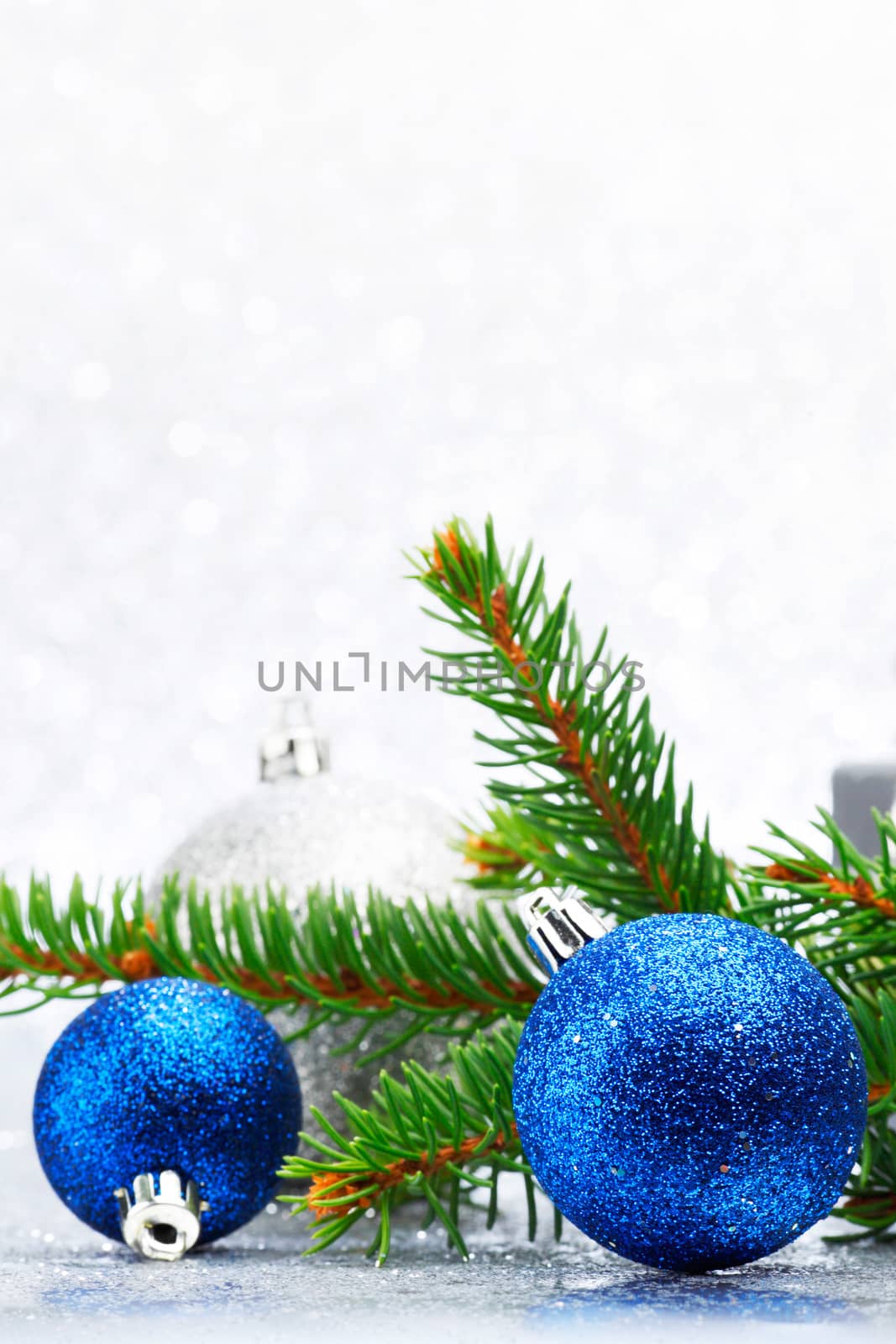 Firtree and christmas decor on glitter silver background