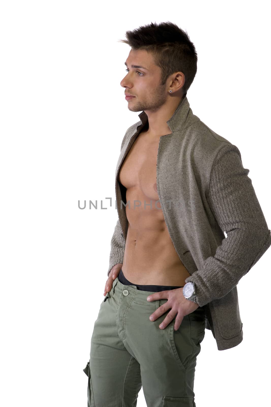 Confident, attractive young man with open jacket on muscular torso, ripped abs and pecs. Side view