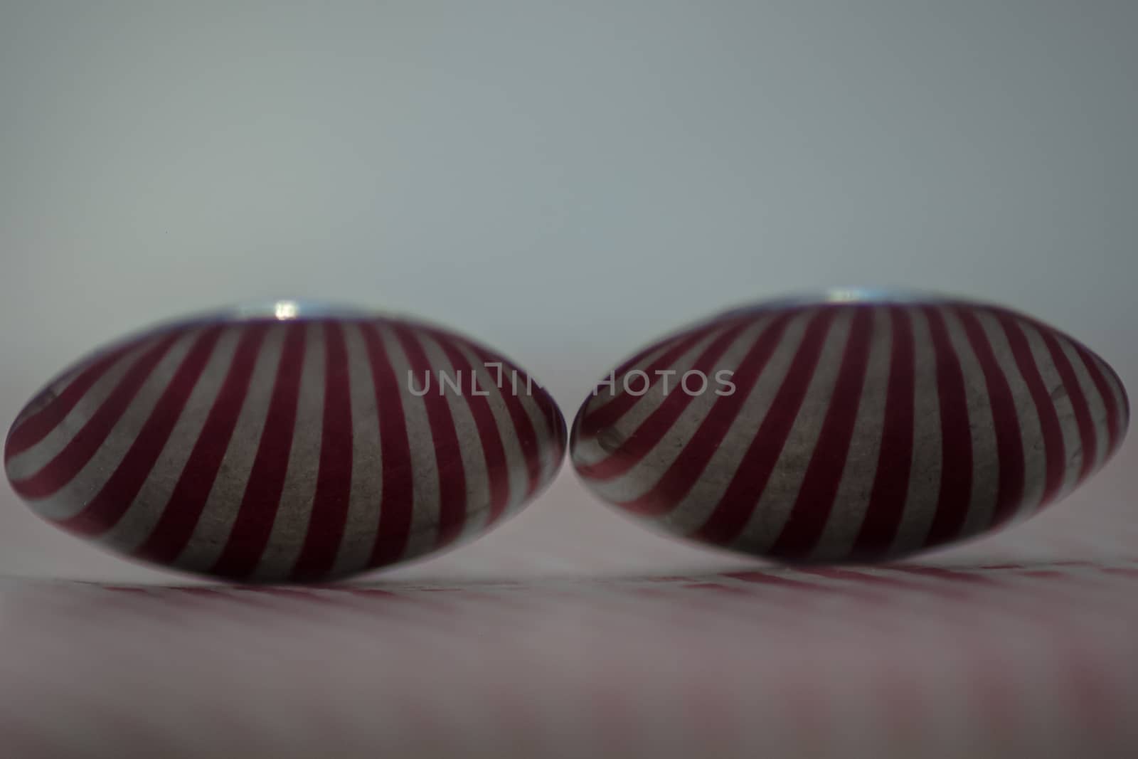 Two spoons composed to reflect red vertical lines