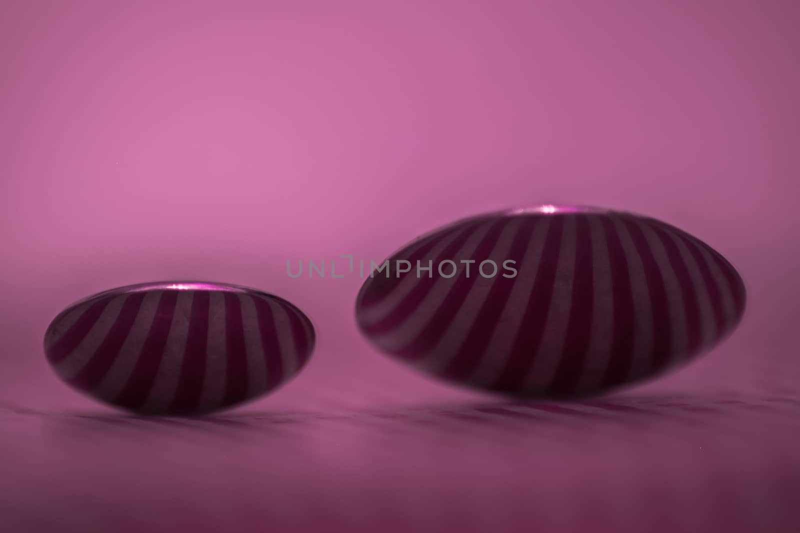 Two spoons composed to reflect vertical lines in pink