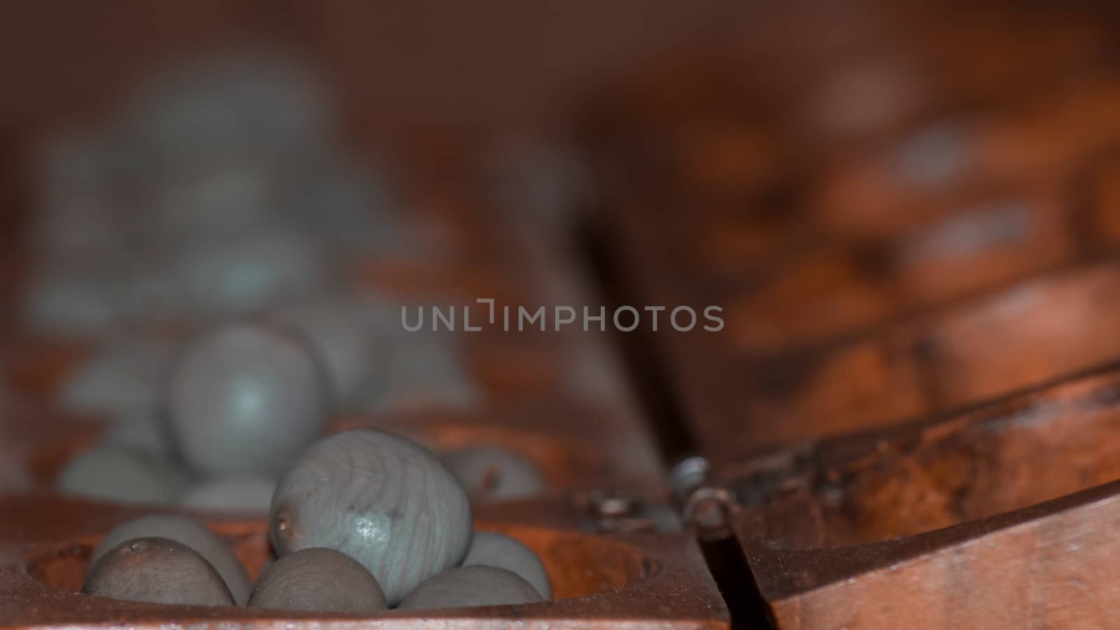 Closeup of a wooden mancala game by arvidnorberg