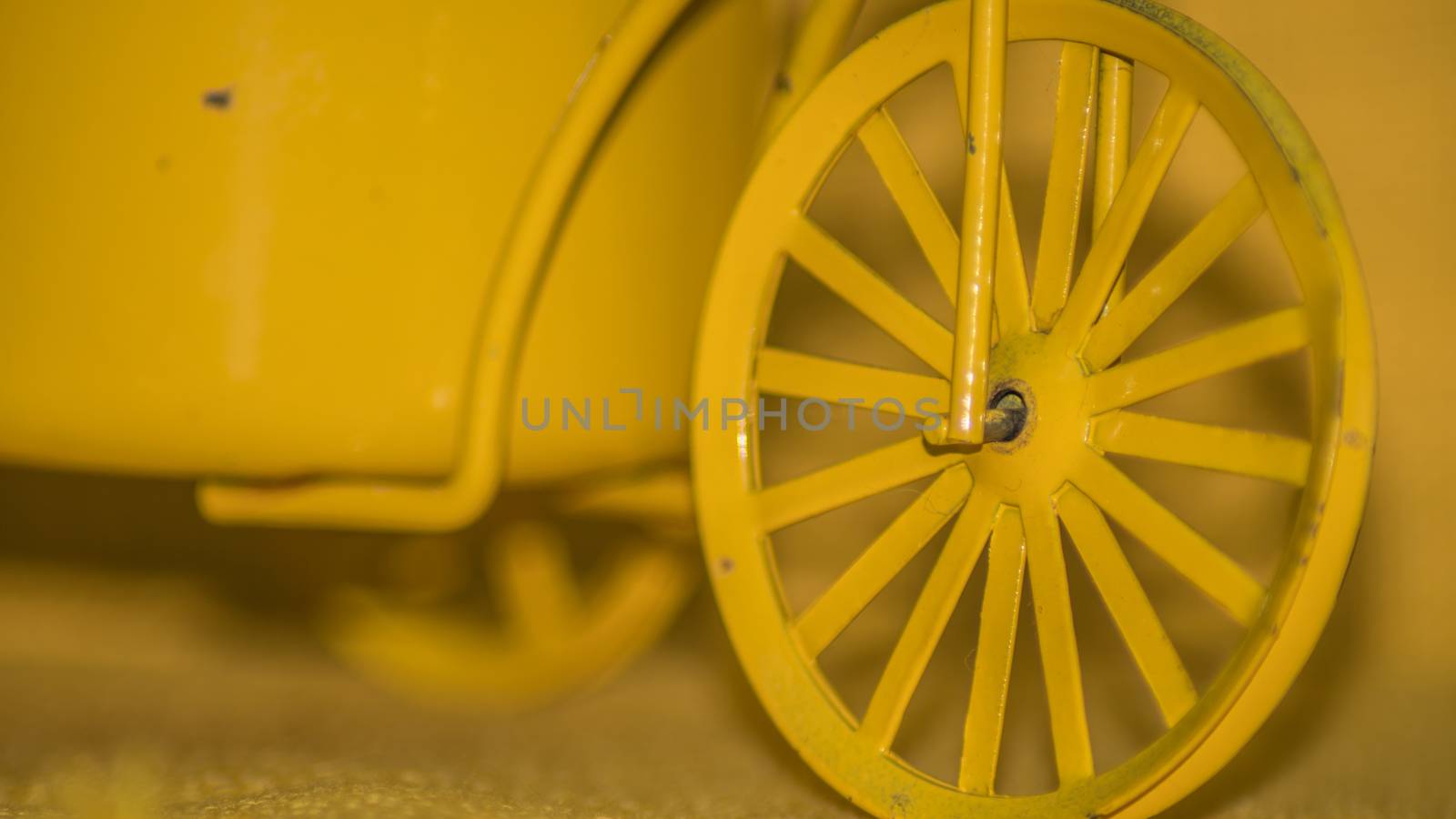 A yellow wheel infront of a yellow background by arvidnorberg