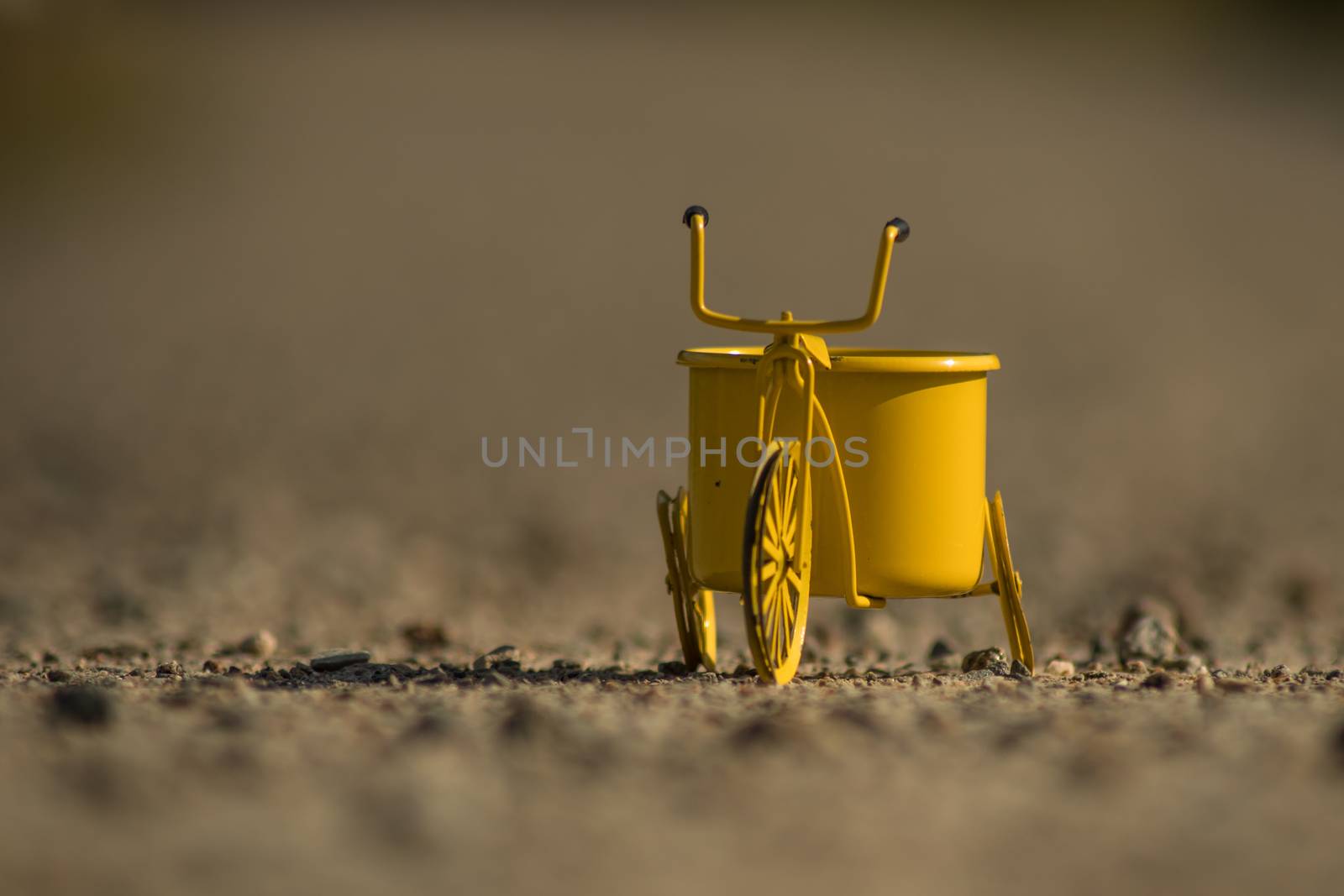A yellow toy bike outdoors by arvidnorberg