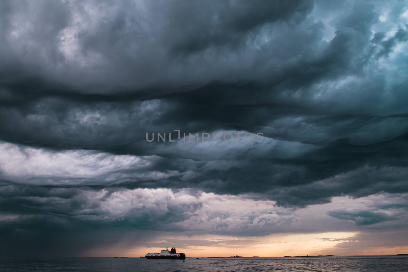 A cargo ship underneath stormy clouds by arvidnorberg