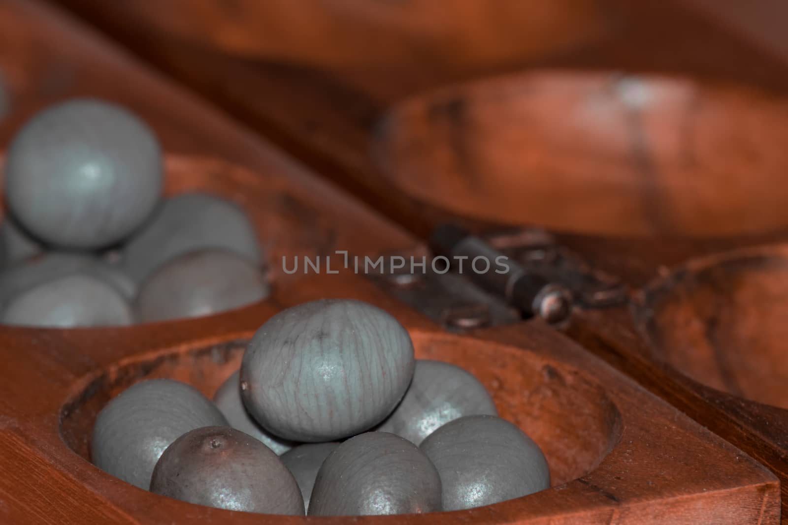 Closeup of a wooden mancala game by arvidnorberg