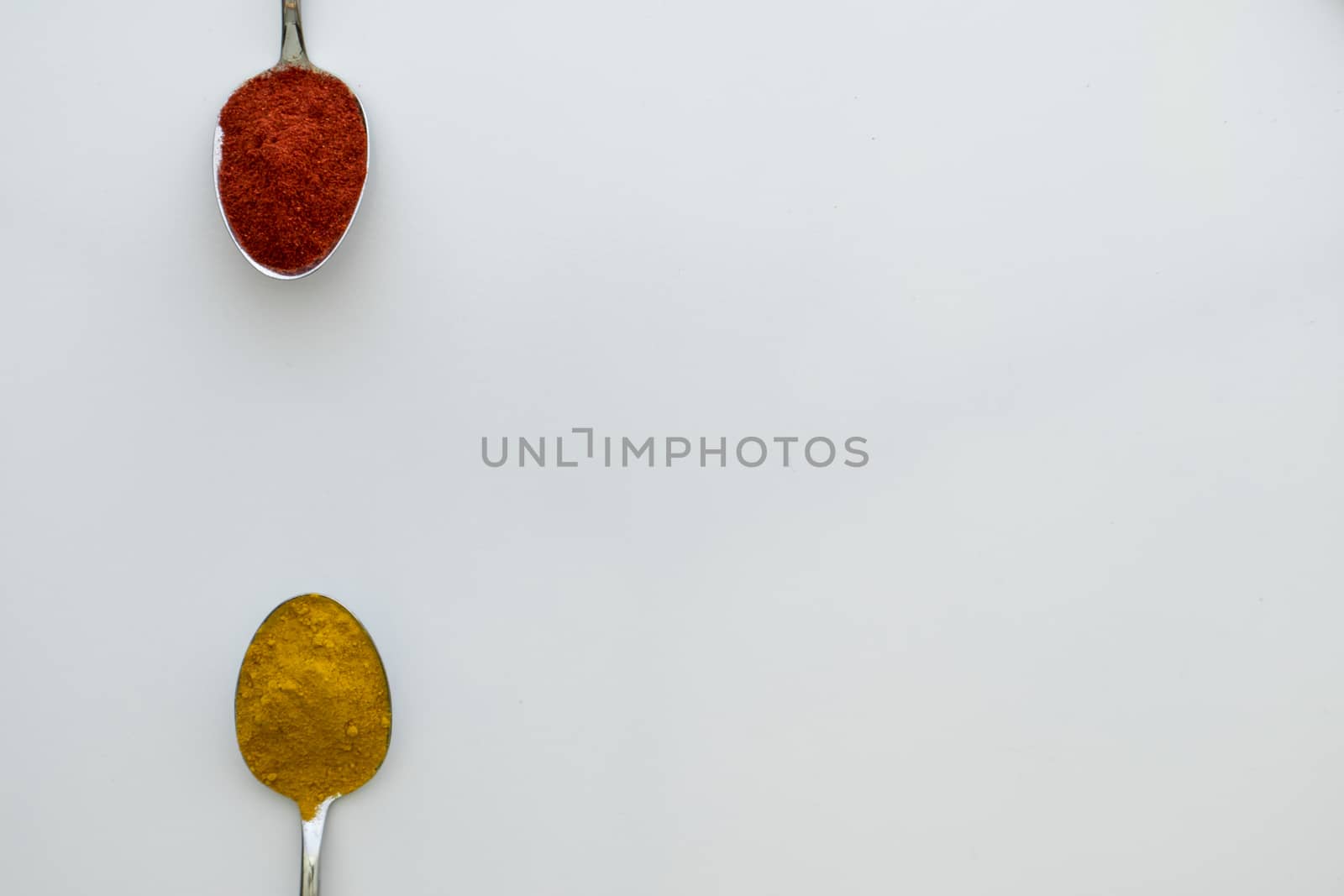 Various colorful spices arranged on spoons  by arvidnorberg