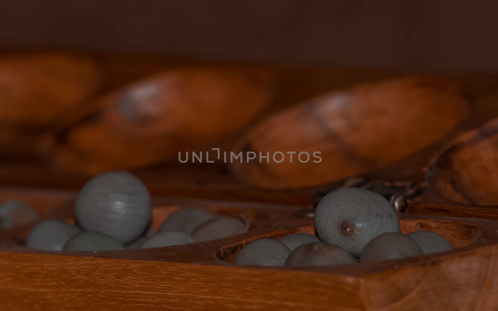 Closeup of a wooden mancala game by arvidnorberg