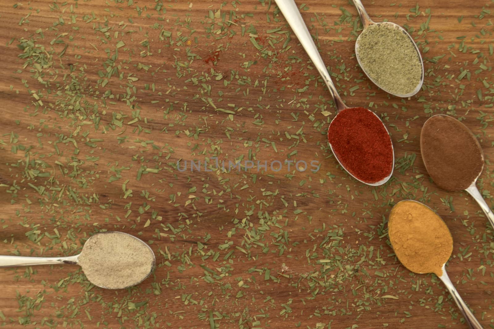 Various colorful spices arranged on spoons  by arvidnorberg